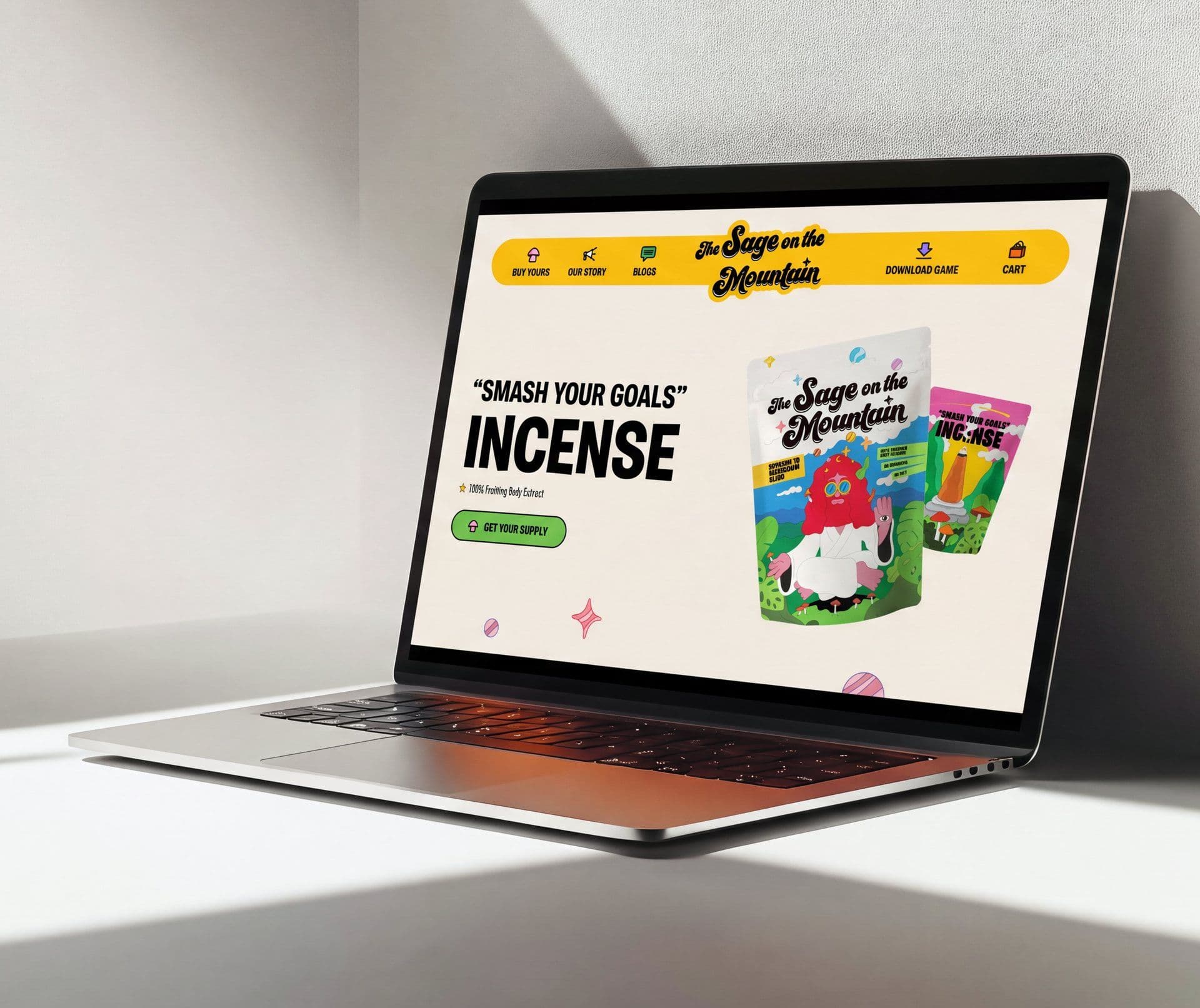 The Sage on the Mountain home page on a laptop — the “Smash Your Goals” incense hero beside the illustrated product pouches